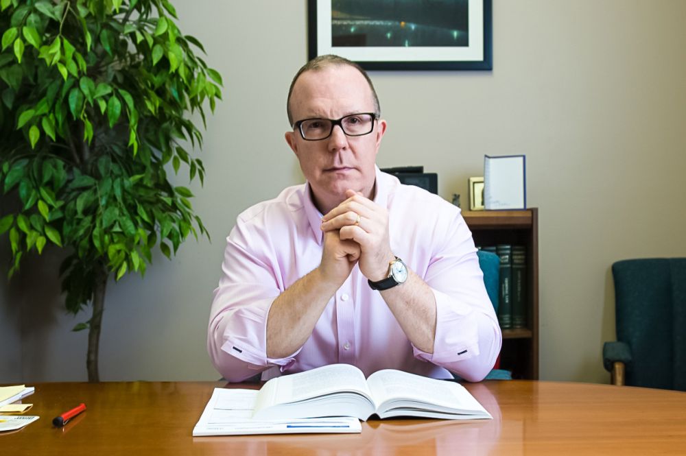 Jeffrey Randa sitting at his desk