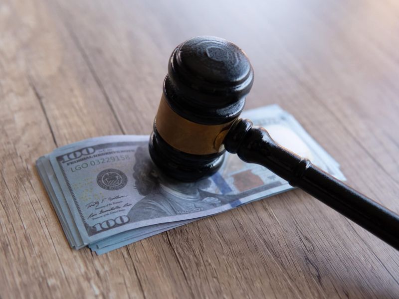 Closeup image of gavel and money. Fine, penalty, bribe concept, lawyer fees.