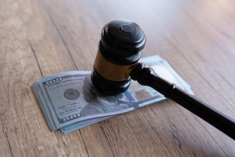 Closeup image of gavel and money. Fine, penalty, bribe concept, lawyer fees.