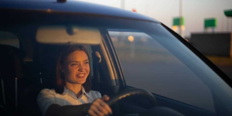 happy woman driving a car