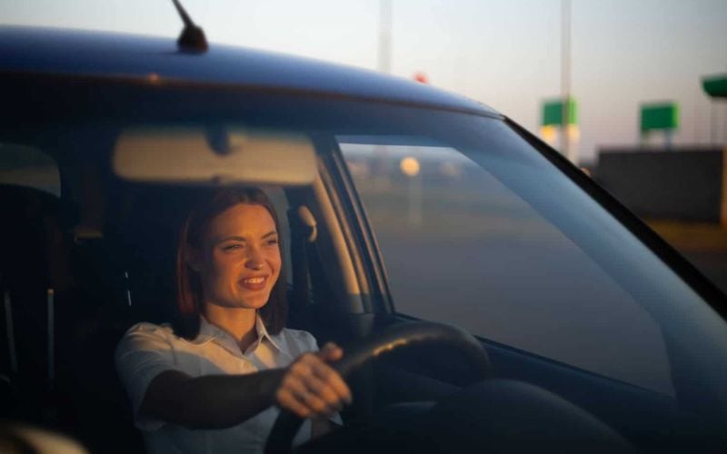 happy woman driving a car