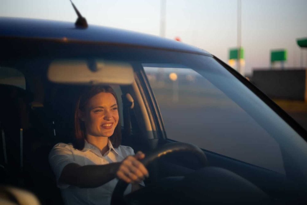 happy woman driving a car