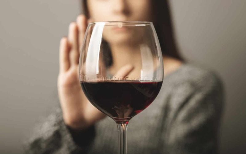 reject liquor, stop alcohol, teenager girl shows a sign of refusal of wine