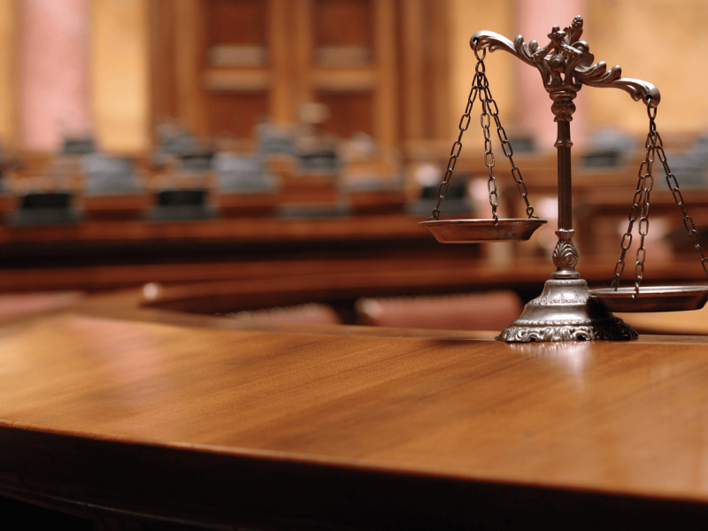 image of legal scales in a courtroom